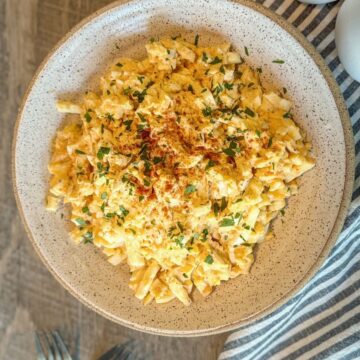 Deviled egg salad in round beige bowl