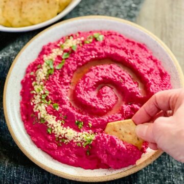 roasted beet and cauliflower hummus in round oatmeal colored bowl