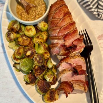 Bacon wrapped pork loin on long oval white plate