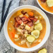 bacon cheeseburger soup in a round white bowl
