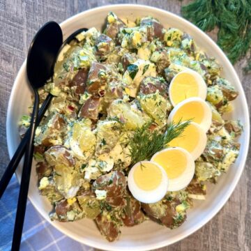 red-skinned potato salad in large round white bowl