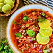 salsa fresca in round white bowl with limes