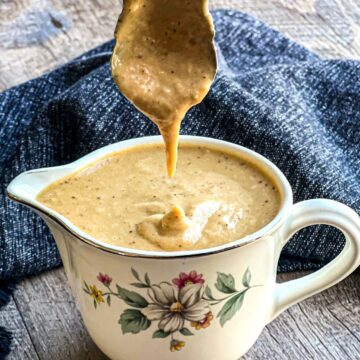 Creamy roasted shallot dressing in hall creamer with antique spoon