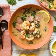 Creole shrimp and sausage soup in orange round bowl