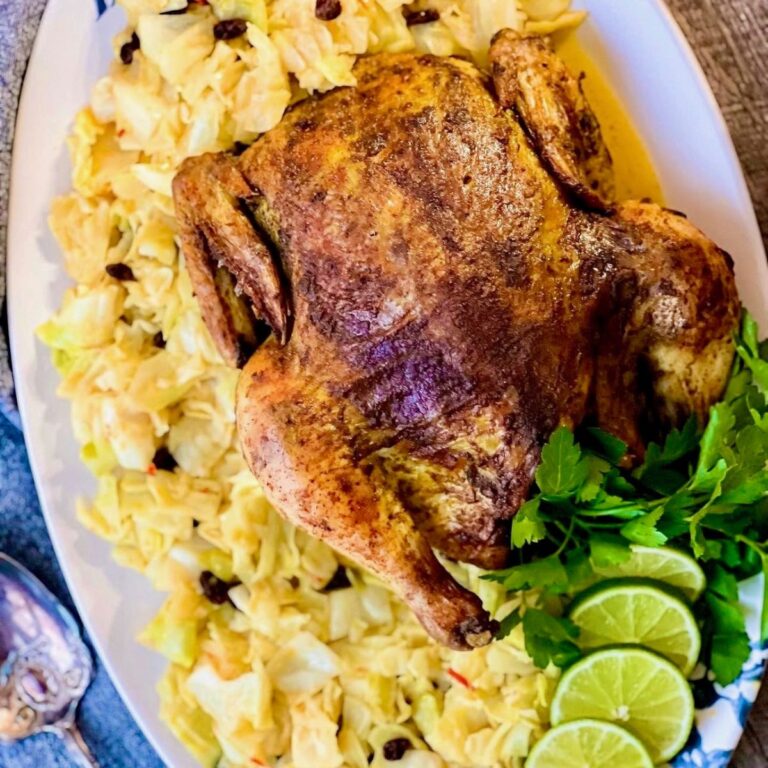 Air fryer curry chicken on large oval plate with cabbage