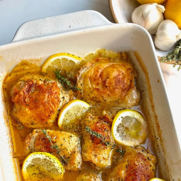 roasted lemon thyme chicken in white rectangular baking dish