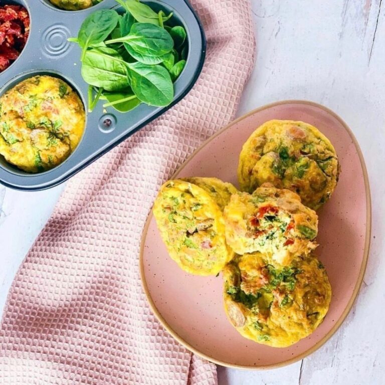 sausage egg muffins on oval plate with muffin tin