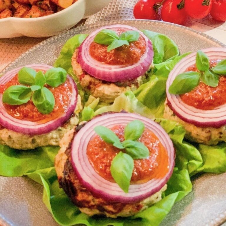 sun-dried tomato chicken burgers with red onion over lettuce buns