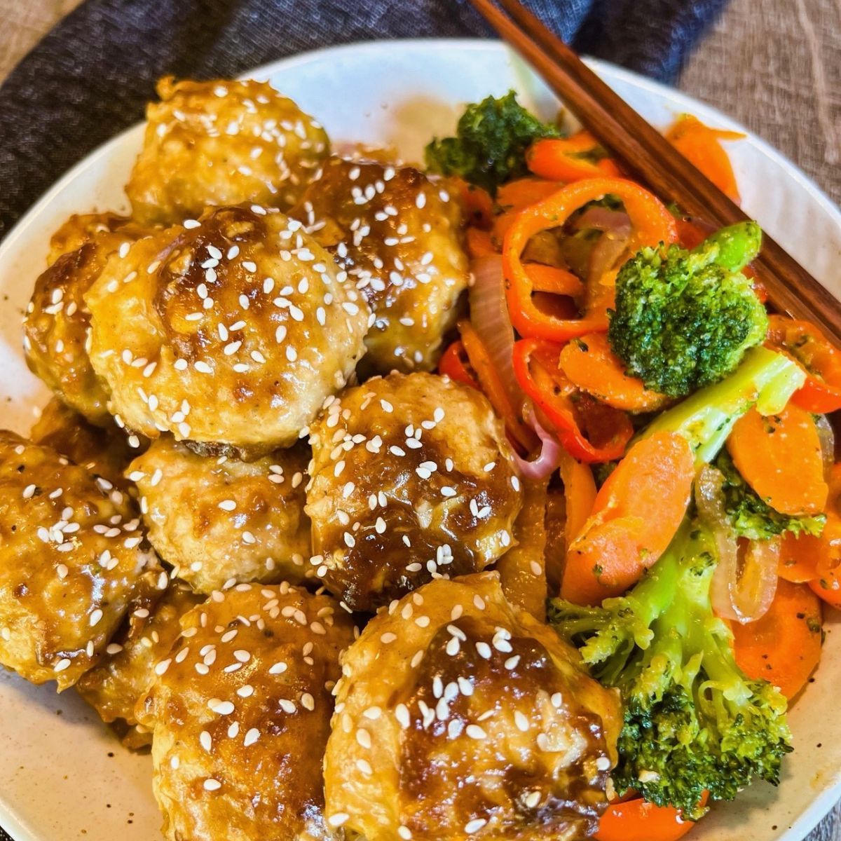 teriyaki chicken meatballs in round white bowl with veggies