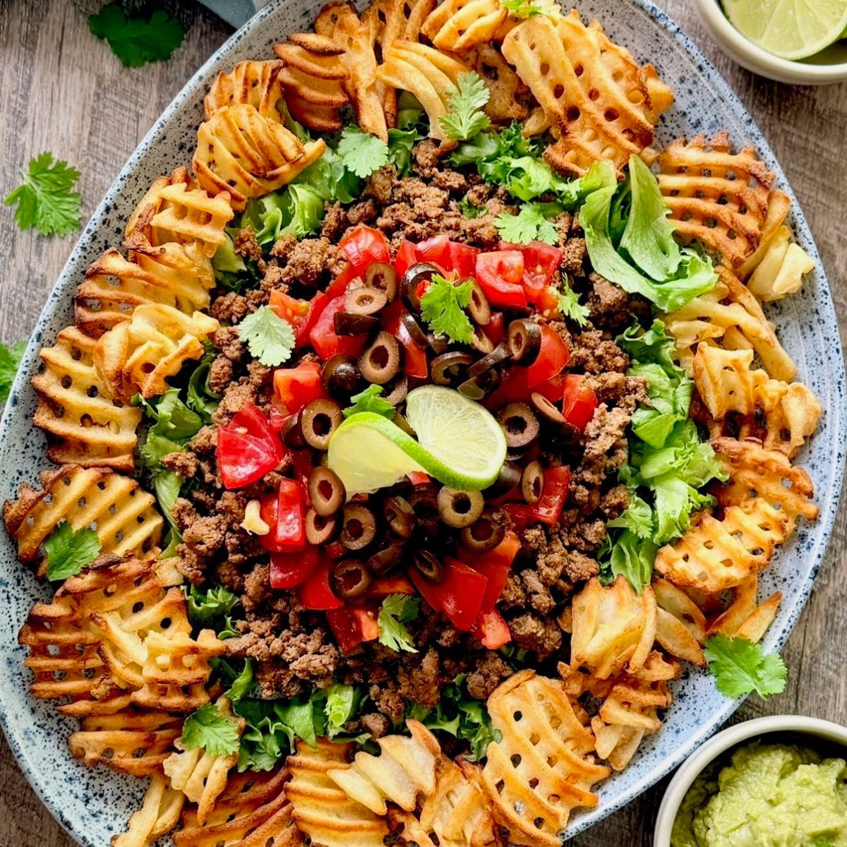 nacho platter on a large blue speckled platter