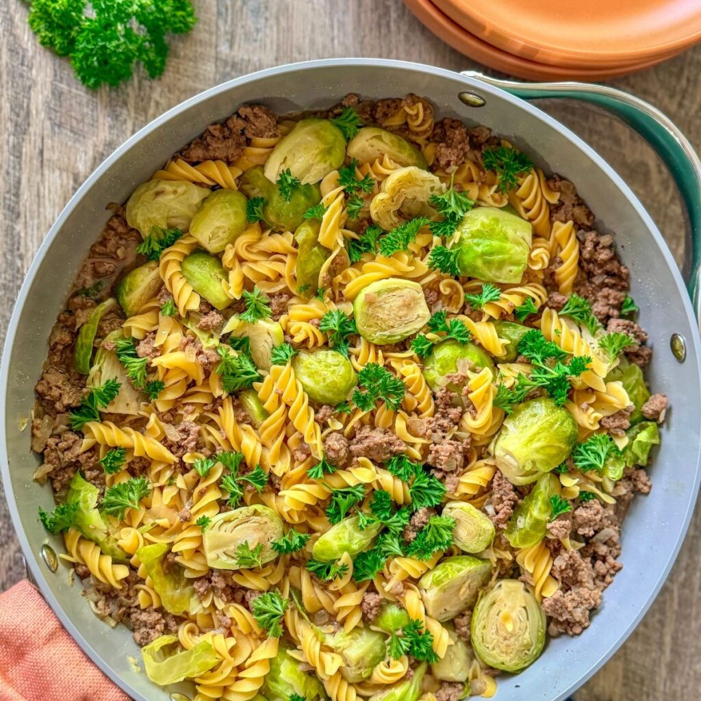 ground beef and brussels sprouts with chickpea pasta in a beef sauce with fresh pasrsley